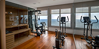 a gym installed into a home with a crosstrainer, and chest press 