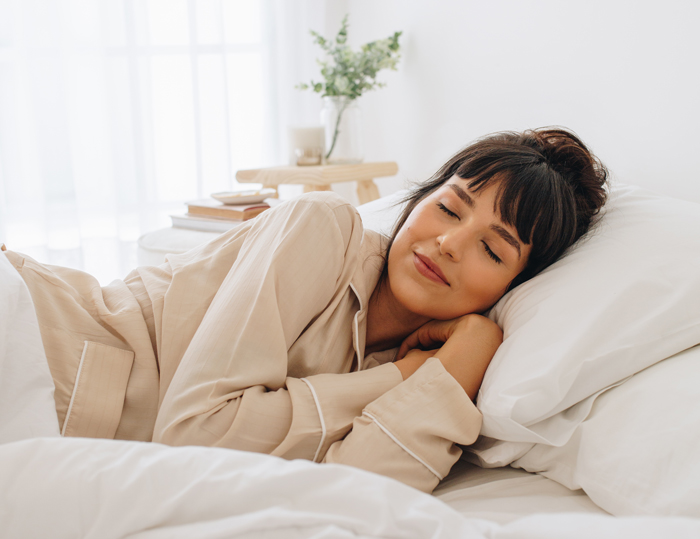 A person sleeping in their bed